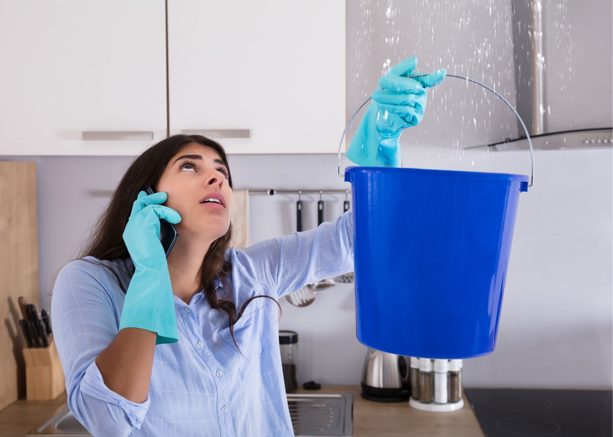 A bucket catching water from a ceiling leak in an Austin, TX home