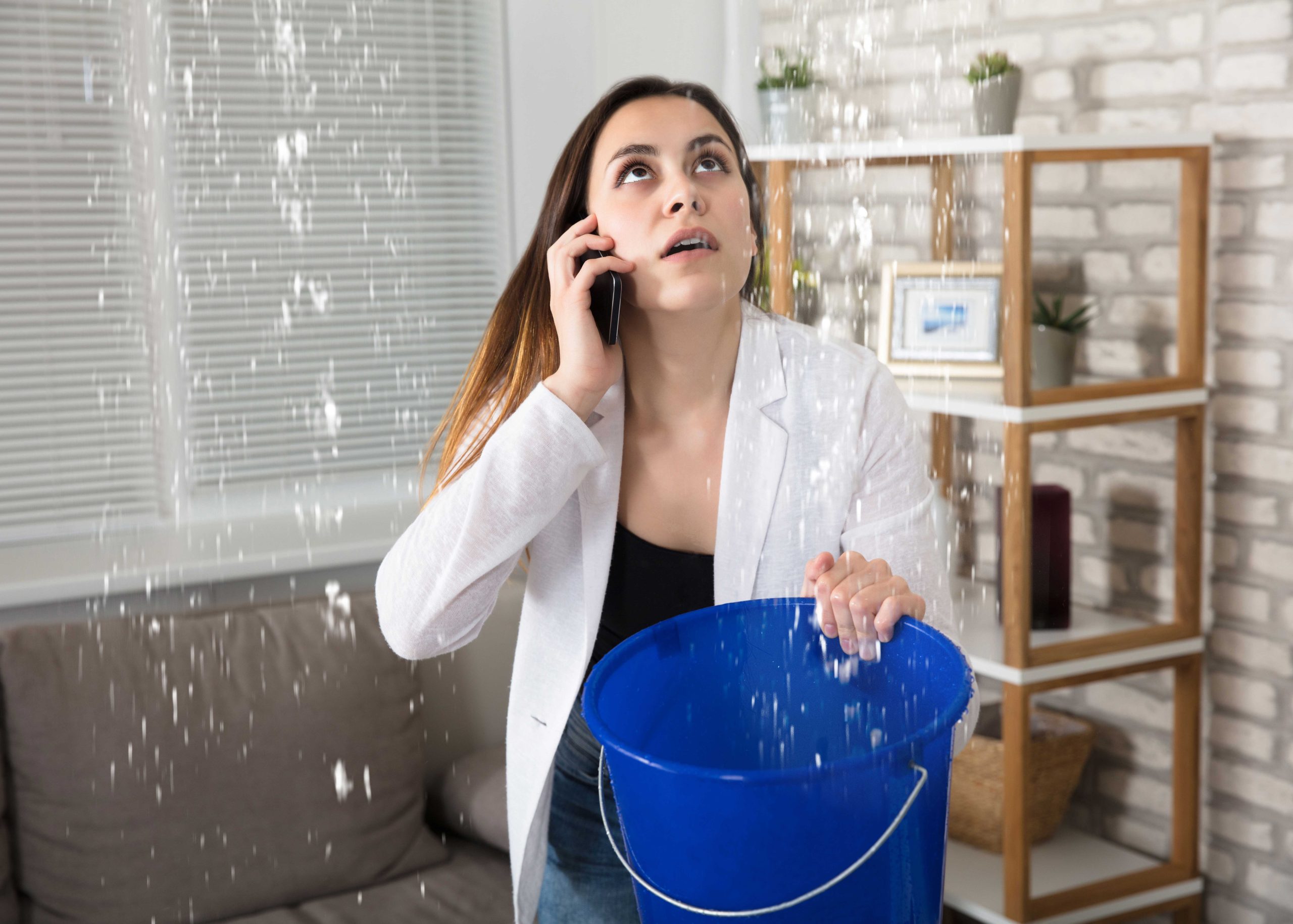 A bucket catching a ceiling leak in a Maple Run, Austin, TX home