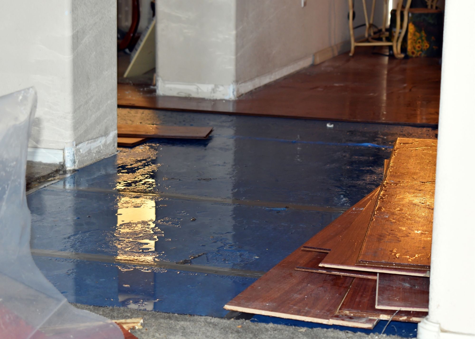 Removing water-damaged flooring material in an Austin, TX home